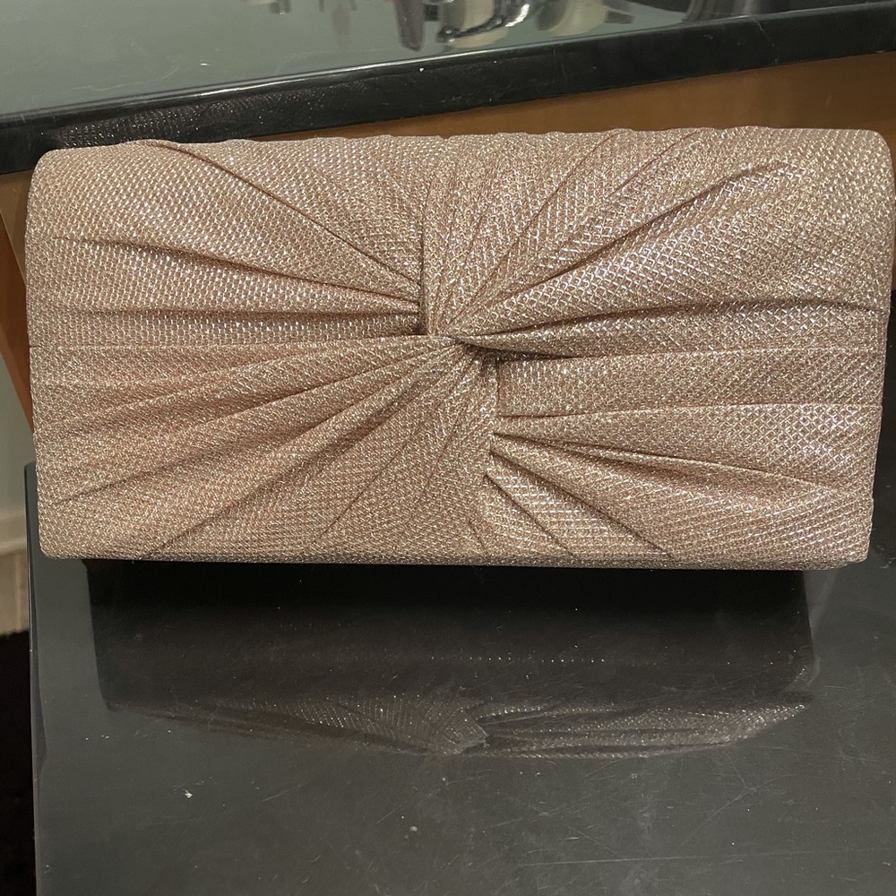 Golden clutch bag with chain link shoulder strap